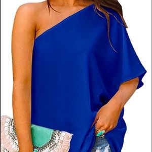 This one shoulder top is a silky material and comes in all sizes .